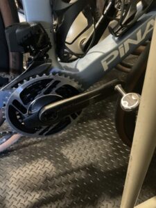 A SRAM RED Crankset with Wahoo pedals on a blue Pinarello.