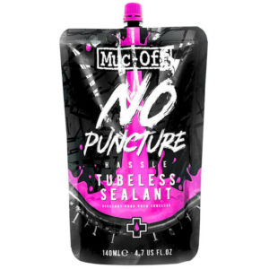 A black and pink pouch of Muc-Off No Puncture Tubeless Sealant - 140 ML against a white background.