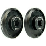 An angled view of two black Praxis M30 Bottom Bracket Socket Tools against a white background.