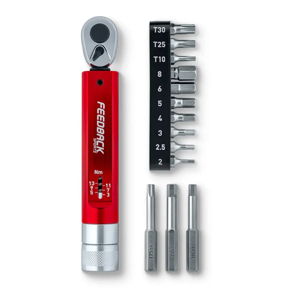 A red and silver Feedback Sports Range Click Torque Wrench with all of the bits it comes with.