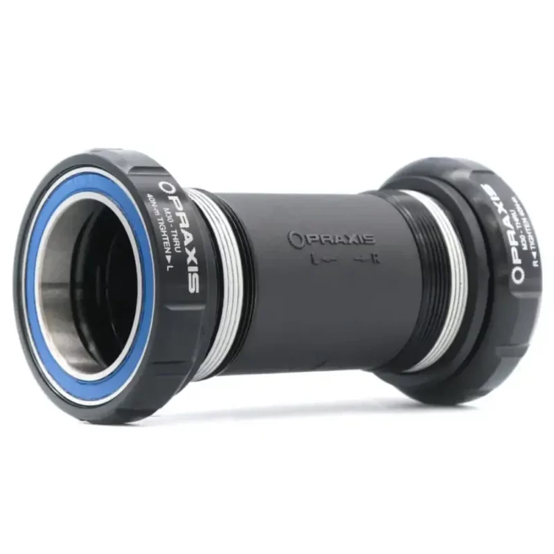 A black Praxis M30 Thru BSA Threaded Bottom Bracket with blue bearing seals.