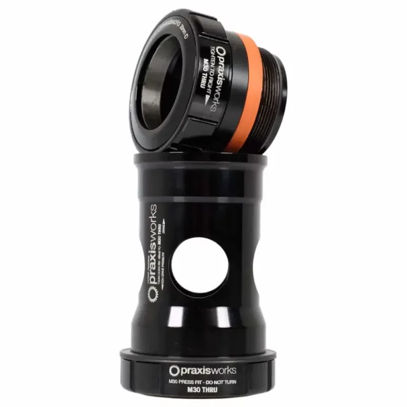 A black Praxis M30 Thru Road BB30 PF30 68MM Bottom Bracket.
