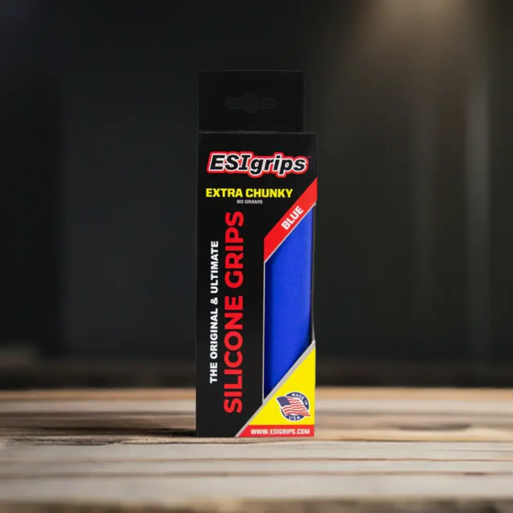 A set of blue ESI Chunky Grips in retail packaging on a wooden table.