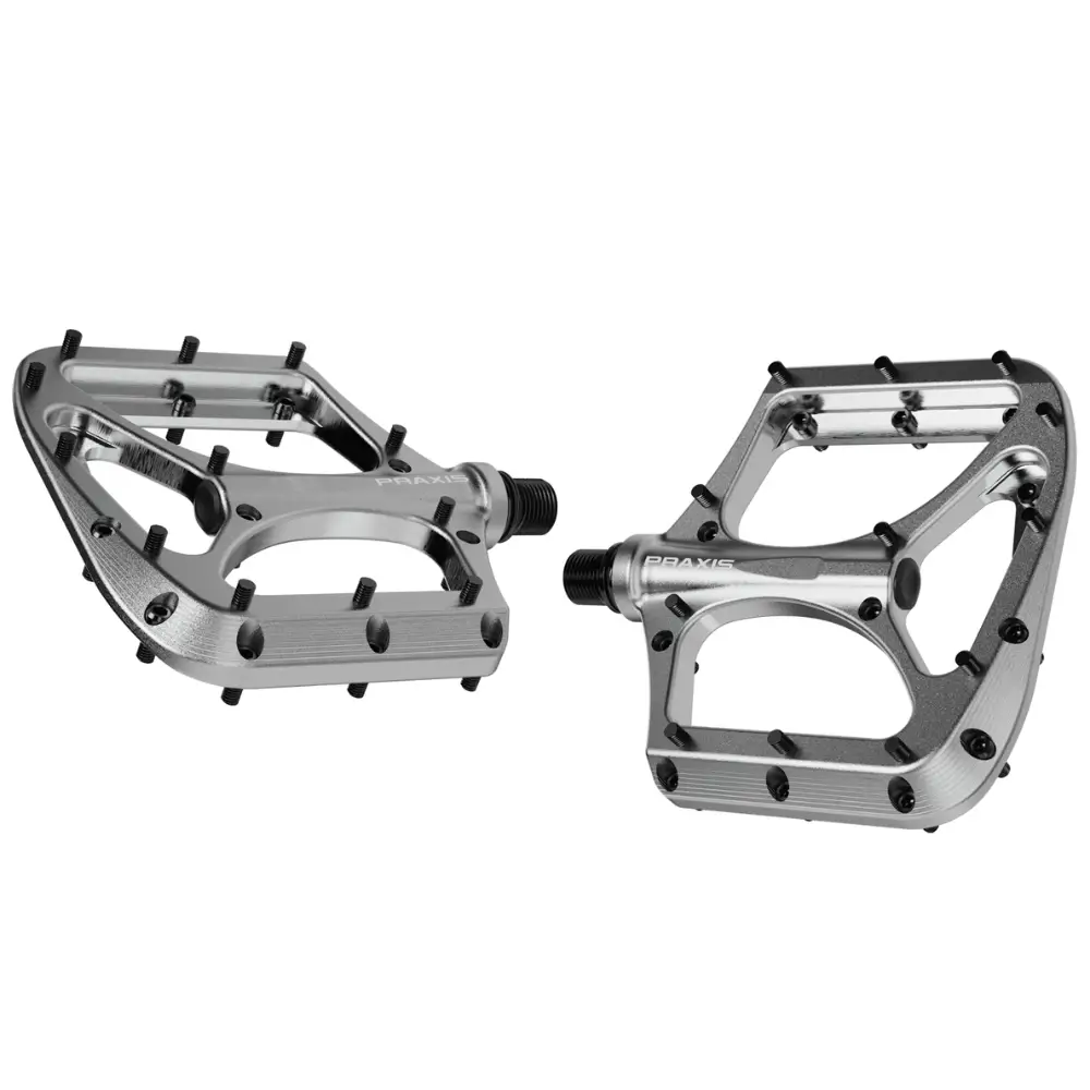 A pair of silver Praxis Works Brodium Mountain Bike Pedals.