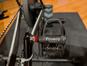 A photo showing a Favero Assioma PRO RS-2 Road Power Meter Pedal installed on a bike that is attached to a trainer.