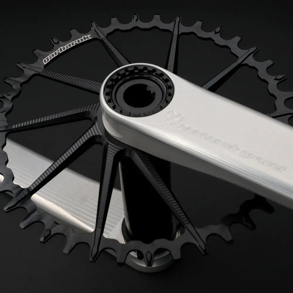 A silver Garbaruk Gravel Crankset with a black Garbaruk chainring installed.