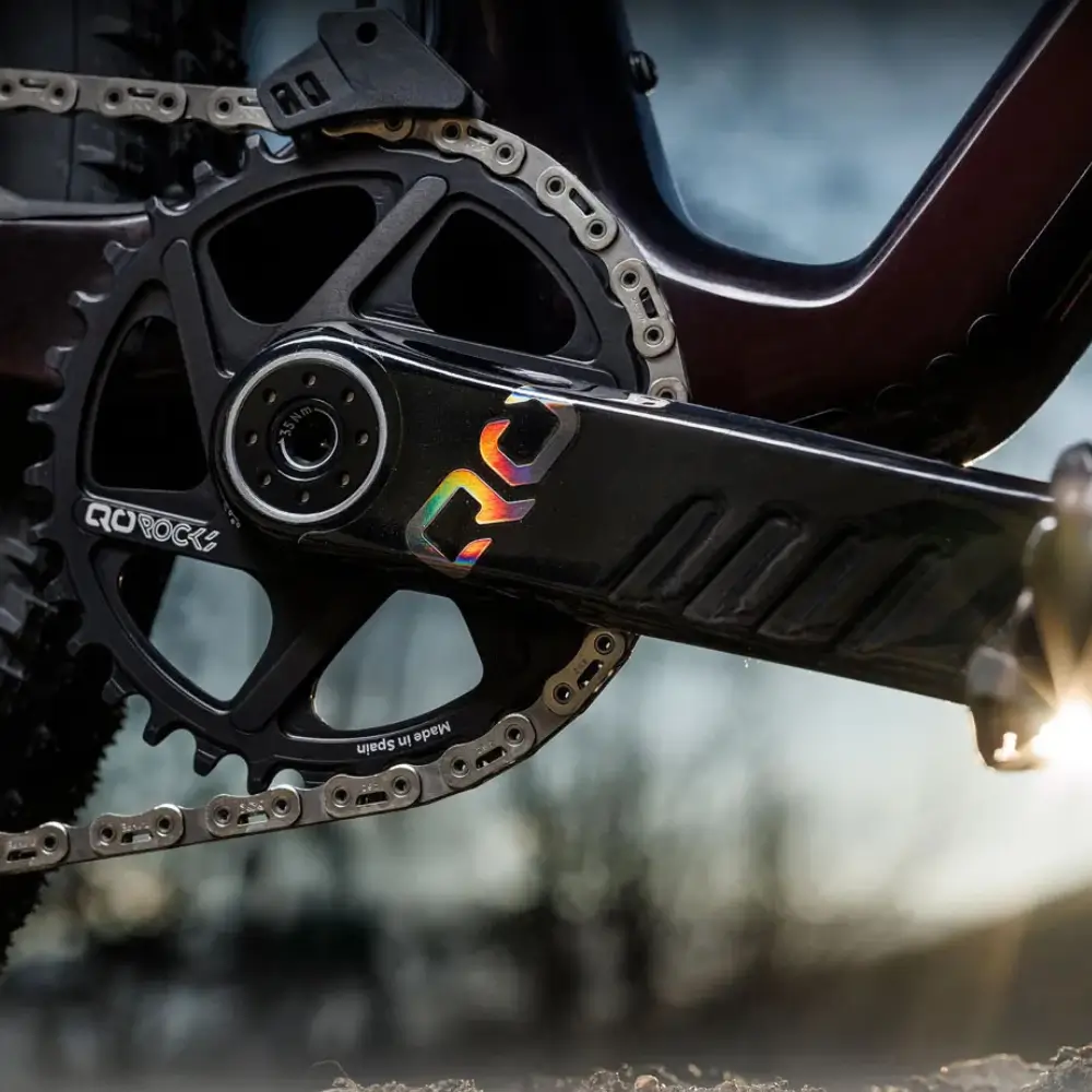 A black QO ROCKS MTB Crankset installed on a bike
