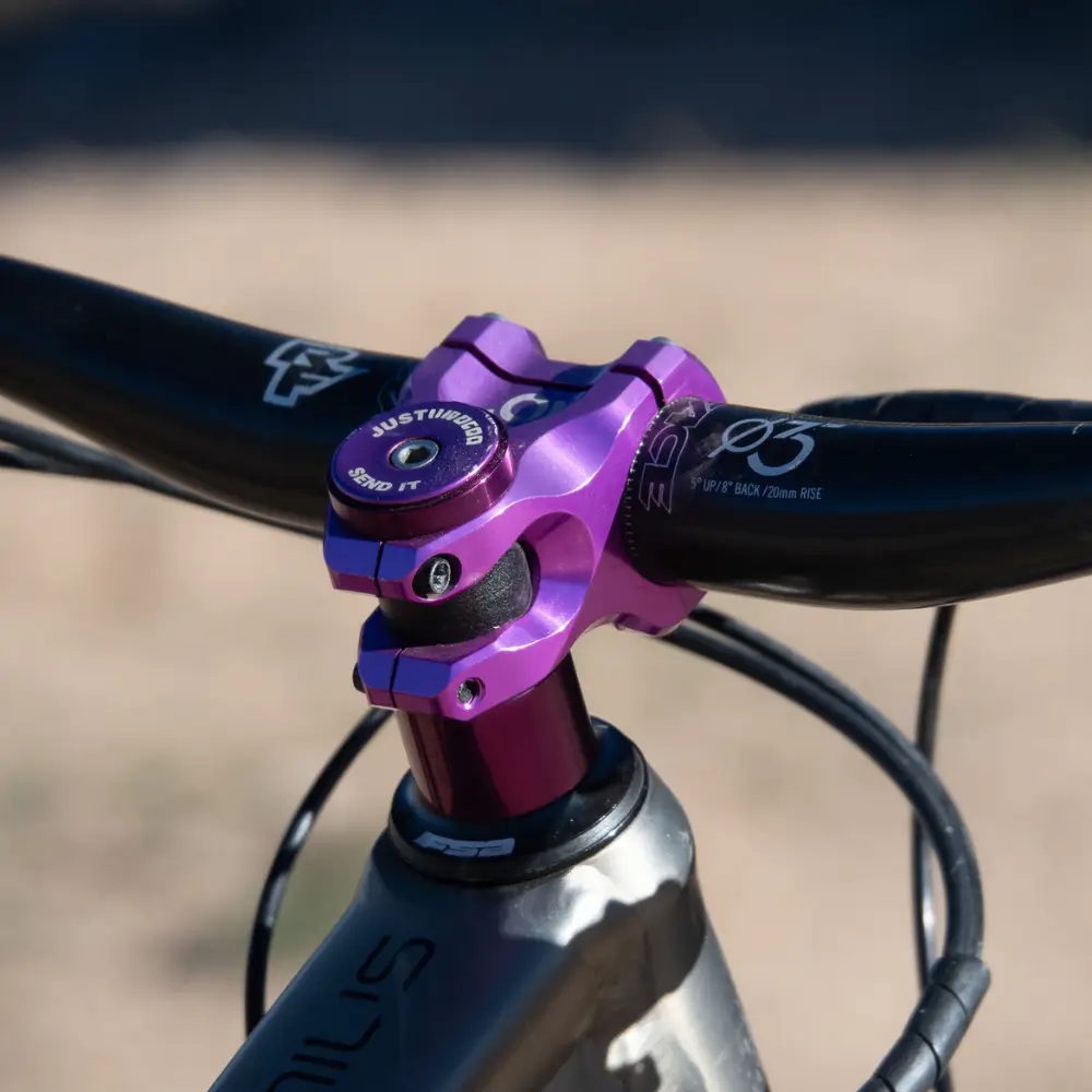 A close up of the cockpit with a purple I9 stem on a Scott Genius.