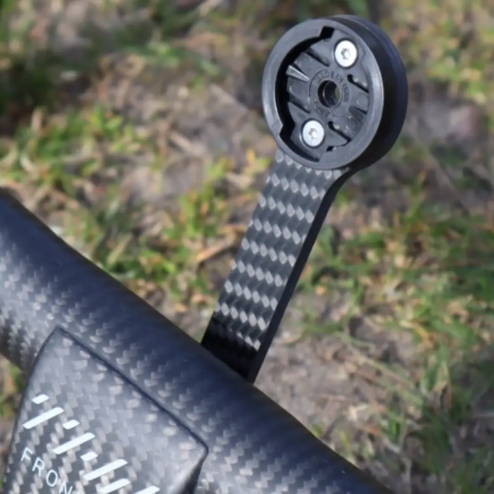A raw carbon THM Frontale ICR Carbon Computer Mount installed on a set of THM Frontale handlebars