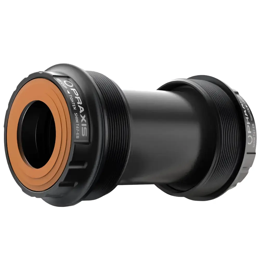 A black and orange Praxis 24MM T47 External Bottom Bracket