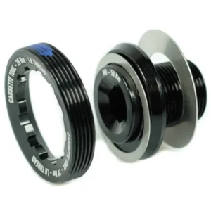 A black Praxis M30 Crank Bolt and Self-Extracting Cap