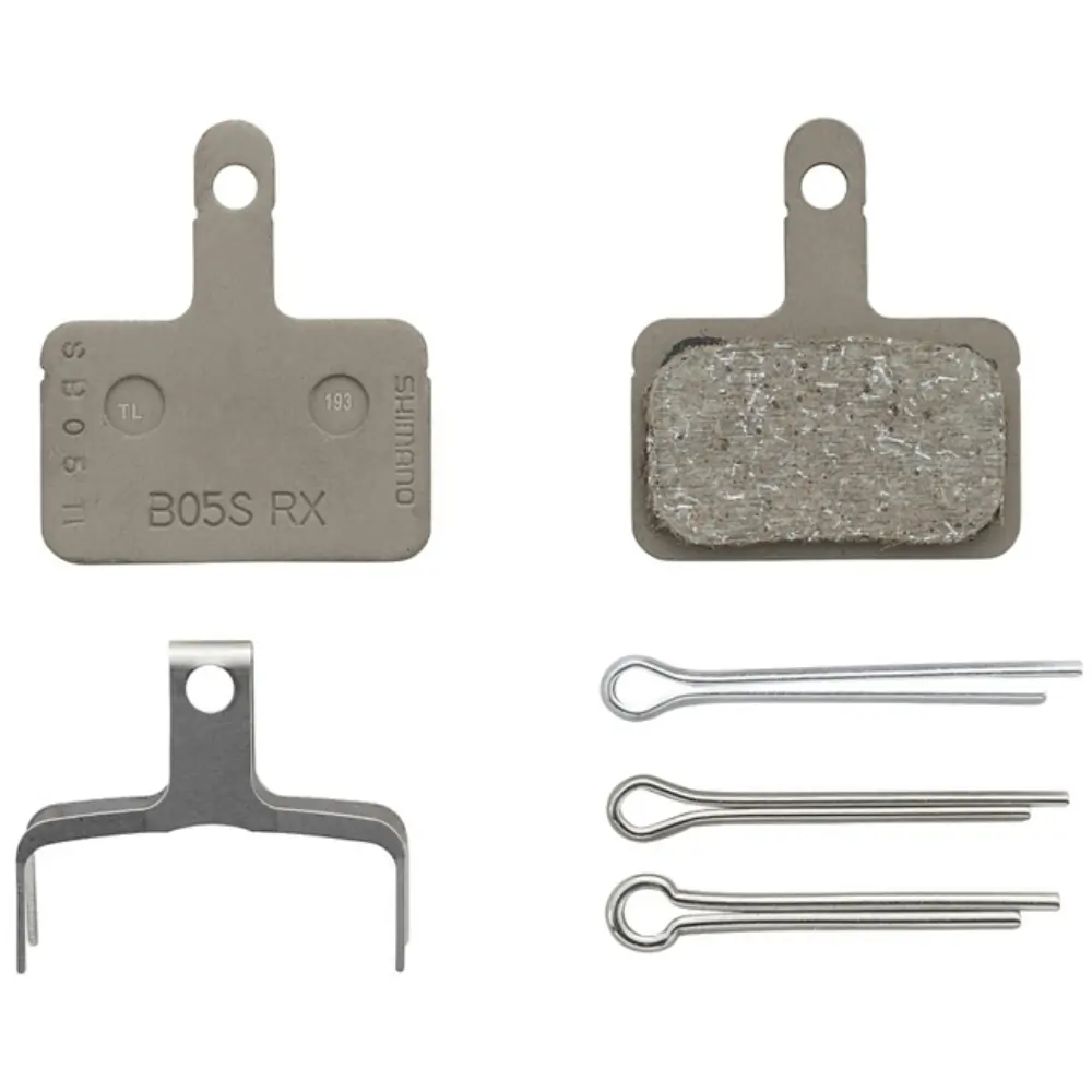 Shimano B05S-RX Resin Disc Brake Pads box contents with two pads, one pad spring and 3 different split pins