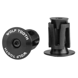 A pair of black Wolf Tooth Alloy Bar End Plugs
