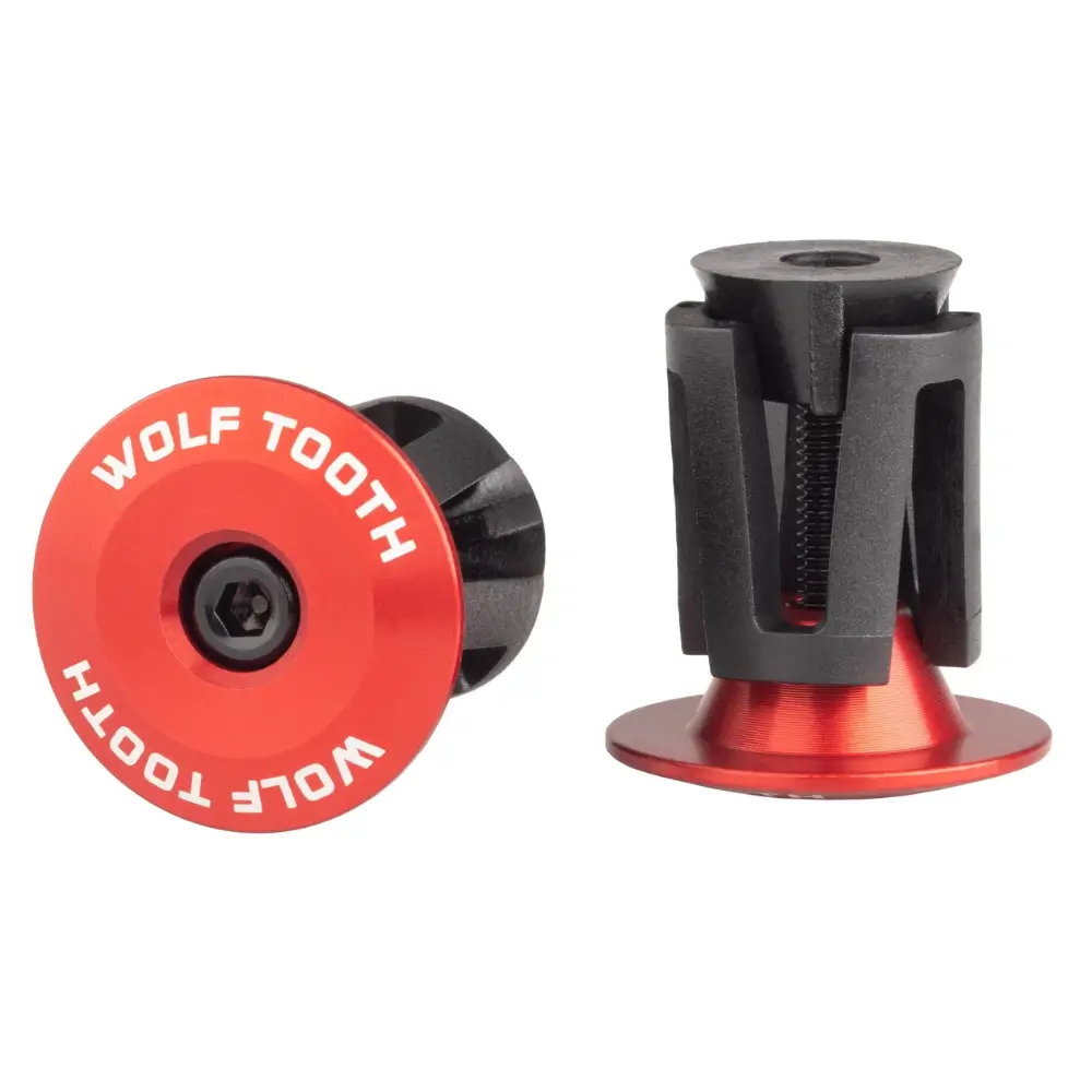 A pair of red Wolf Tooth Alloy Bar End Plugs