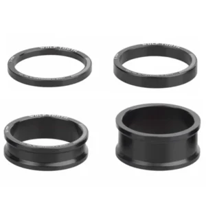 A black Wolf Tooth Precision Headset Spacer Kit with 4 different sized spacers