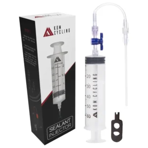 A KOM Cycling Tubeless Sealant Injector showing the box, the injector and valve core tool