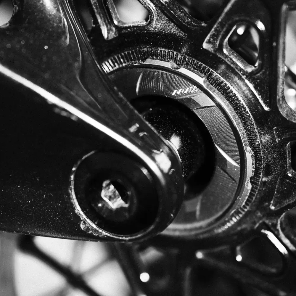 A grey Wolf Tooth MK0 Centerlock Rotor Lockring - External Spline installed on a brake rotor