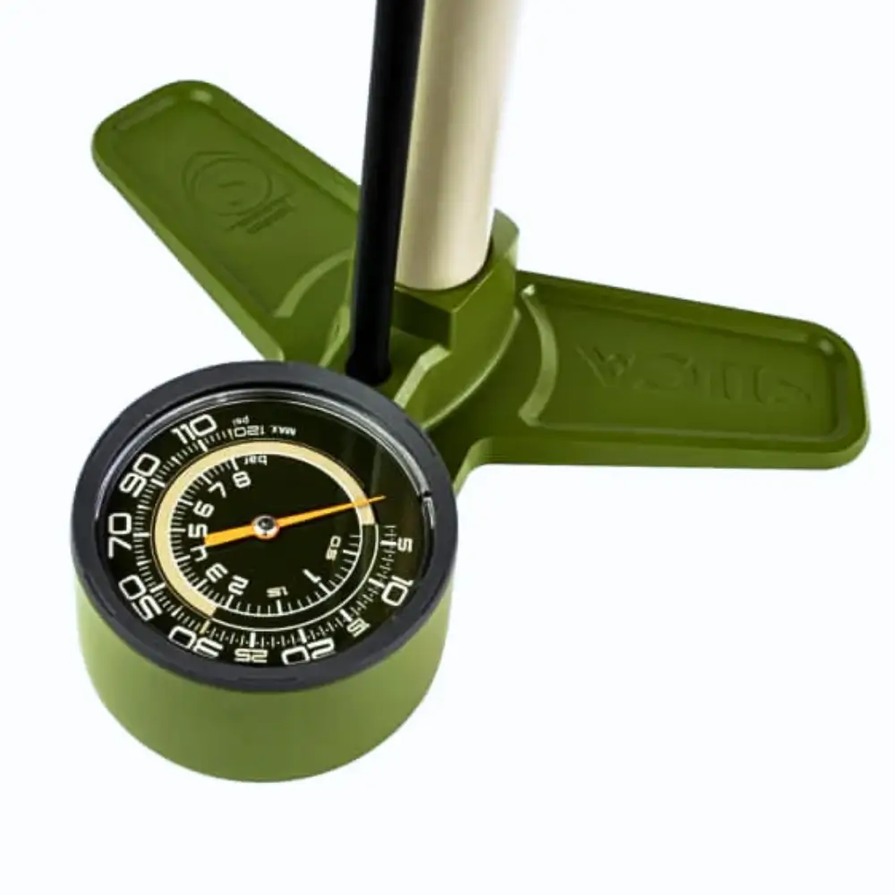 The dial of a green and silver Silca Terra Floor Pump on a white background